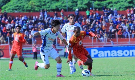 Pemain tengah Semen Padang FC, Elie Aiboy (kanan), mencoba melewati hadangan pemain sepak bola Warriors FC saat pertandingan Piala Asian Football Confederation (AFC) 2013 di Stadion Agus Salim, Padang, Selasa (5/3). 