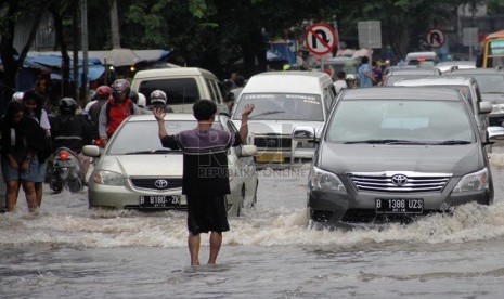   Kendaraan terjebak banjir saat mencoba melintasi ruas jalan yang menghubungkan Ciledug dengan Cipulir di Jakarta Selatan, Rabu  (29/1).     (Republika/Yasin Habibi)