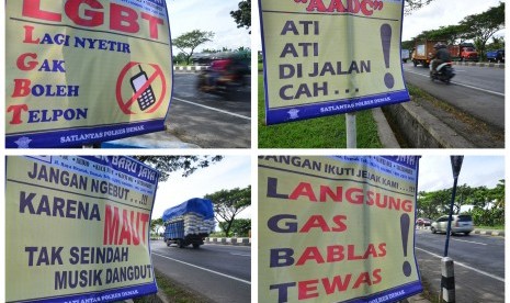 Spanduk ajakan tertib berlalu-lintas di jalan jalur Pantura Demak-Kudus, Jawa Tengah.