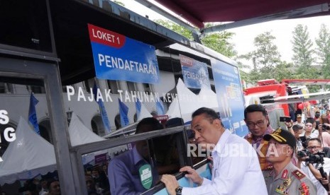 Dari kiri ke kanan, Menteri Pendayagunaan Aparatur Negara dan Reformasi Birokrasi (PANRB) Syafruddin, Kapolda Jawa Barat Irjen Pol Agung Maryoto dan Gubernur Jawa Barat Ridwan Kamil meninjau loket pembayaran pajak kendaraan usai peluncuran inovasi pelayanan Samsat Jawa Barat Ngabret (J'bret) di halaman Gedung Sate, Kota Bandung, Senin (28/1).