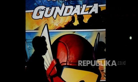 Undangan melintas di dekat neon box Gundala saat gala premiere  film Gundala di Epicentrum, Kuningan, Jakarta, Rabu (28/8).