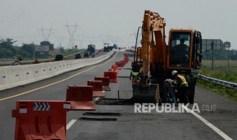 Pekerja saat menyelesaikan perbaikan Jalan Tol Pejagan-Pemalang Kilometer 316, Kabupaten Pemalang, Jawa Tengah, Selasa (7/5).