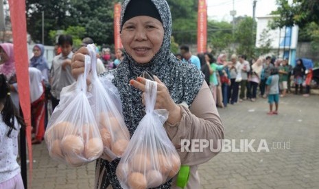 Operasi Pasar Telur Ayam. Warga mengantri membeli telur ayam saat operasi pasar di Toko Tani Indonesia Center (TIIC), Jakarta, Kamis (19/7).