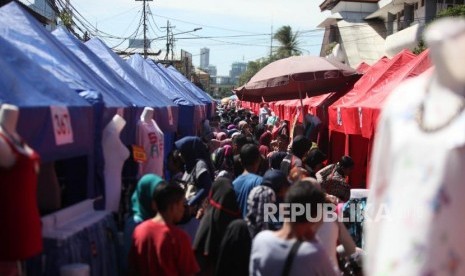 Suasana warga yang melihat-lihat barang distan pedagang kaki lima (PKL) di Kawasan Tanah Abang, Jakarta, Senin (25/12).