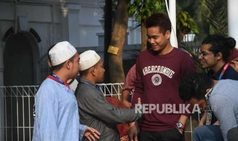 Warga bersalaman bersama atlet Indonesia Tontowi Ahmad usai melaksanakan salat Idul Adha di Masjid Al-Bina komplek Gelora Bung Karno, Jakarta, Rabu (22/8).