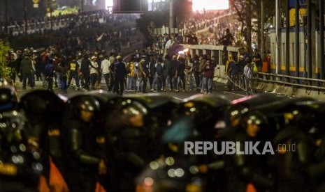 Sejumlah mahasiswa berhadapan dengan polisi saat terjadi kericuhan di depan Gedung DPR, Jakarta, Selasa (24/9).