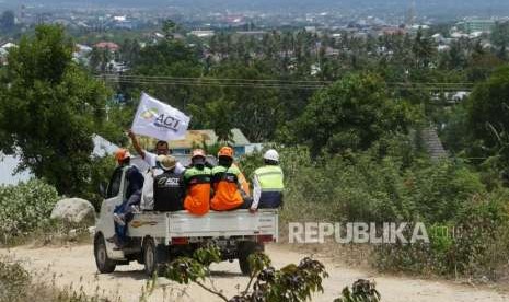 Tim Relawan ACT melintasi perbukitan saat menuju tempat pengungsian warga korban gempa tsunami di  tempat pengungsian Duyu, Palu Barat, Kecamatan Tatanga, Selasa (9/10).