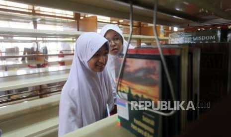 Sejumlah siswi mencari buku sejarah saat mengikuti belajar bersama di Perpustakaan Nasional, Jakarta, Kamis (27/9).