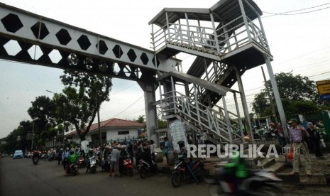 JPO Pasar Minggu. Kendaraan melintas di dekat Jembatan Penyeberangan Orang (JPO) yang rusak di Pasar Minggu, Jakarta, Selasa (5/3).