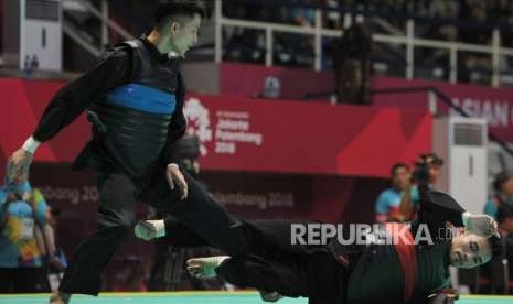 Pesilat Indonesia Abdul Malik (pita merah) bertanding melawan pesilat Vietnam Dinh Tuan Nguyen pada babar penyisihan cabang pencak silat putra kelas B 50-55 kg Asian Games 2018 di Padepokan Pencak Silat TMII, Jakarta, Kamis (23/8).