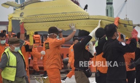 Petugas SAR gabungan mengevakuasi puing pesawat Lion Air JT 610 saat tiba Posko Terpadu Pelabuhan Tanjung Priok, Jakarta, Sabtu (3/11).