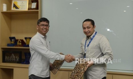 Direktur Operasional Republika Arys Hilman (kiri) dan Pimpinan Unit Usaha Syariah BFI Finance Deni Nasri bersalaman usai penandatanganan nota kesepahaman (MoU) di Kantor Republika, Jakarta, Rabu (7/8).