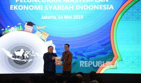 Menteri PPN/Kepala Bappenas Bambang Brodjonegoro memberikan masterplan ekonomi syariah Indonesia kepada Direktur Eksekutif KNKS Ventje Rahardjo pada acara peluncuran masterplan ekonomi syariah Indonesia 2019-2024 di Jakarta, Selasa (14/5).