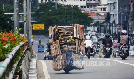 Sebuah sepeda motor dengan bermuatan tumpukan kardus bekas melintas di kisaran fly over Senen Jakarta, Selasa (4/7). Membawa barang dengan kapasitas berlebih pada sepeda motor dapat membahayakan dipengendara dan pengguna jalan lainnya. Foto: darmawan.