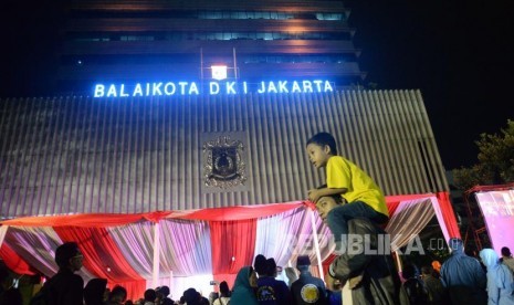 Sejumlah warga Jakarta mengikuti acara pesta rakyat pelantikan Gubernur dan Wakil Gubenrur DKI Jakarta Anies-Sandi di halaman Balaikota, Jakarta, Senin (16/10) malam.