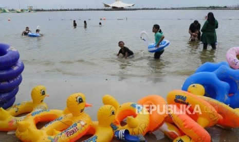 Sejumlah anak bermain di pinggiran pantai Taman Impian Jaya Ancol Jakarta, Selasa (25/12).