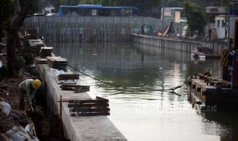 Pekerja dari Dinas Sumber Daya Air Pemerintah Provinsi (Pemprov) DKI Jakarta menyelesaikan pembangunan normalisasi di Kali Ciliwung lama, Jalan Veteran, Jakarta, Rabu (10/10).