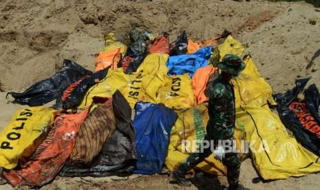 Sejumlah Prajurit TNI melakukan penguburan massal terhadap jenazah korban gempa bumi dan tsunami di Taman Pemakaman Umum (TPU) Poboya Indah, Palu, Sulawesi Tengah, Selasa (2/10).