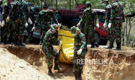 Sejumlah Prajurit TNI melakukan penguburan massal terhadap jenazah korban gempa bumi dan tsunami di Taman Pemakaman Umum (TPU) Poboya Indah, Palu, Sulawesi Tengah, Selasa (2/10).