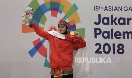 Puspa Arumsari saat meraih medali emat cabang pencak silat kelas artistik tunggal putri Asian Games 2018 di Padepokan Pencak Silat TMII, Jakarta, pada 2018 lalu. Di PON Papua tahun ini, Puspa menjadi anggota Kontingen DKI Jakarta. 