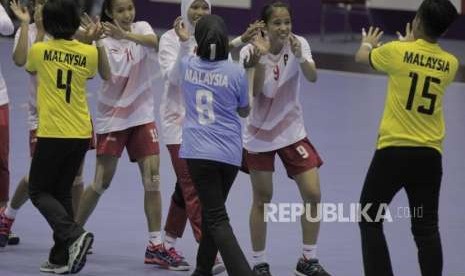 Pemain bola tangan Indonesia menyalami para pemain Malaysia usai menangi pertandingan di babak penyisihan group B   Asian Games 2018, di GOR POPKI, Cibubur, Jakarta, Selasa (14/8).