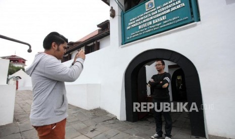 Pengunjung berfoto di latar Museum Bahari, Penjaringan, Jakarta, Rabu (24/1).