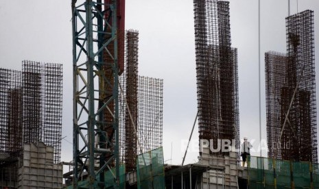 Pertumbuhan Ekonomi. Pekerja beraktivitas pada proyek pembangunan gedung bertingkat di Jakarta, Selasa (12/3).