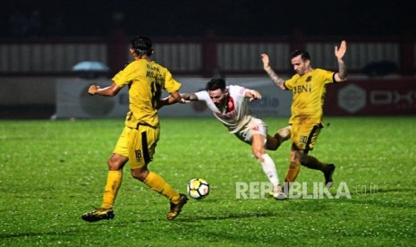 Gelandang PSM Makassar Mark Anthony Klok (tengah) dijatuhkan oleh Gelandang Bhayangkara FC Paulo Sergio (kanan) pada pertandingan Go-Jek Liga 1 2018 di Stadiun PTIK, Jakarta, Senin (3/12).