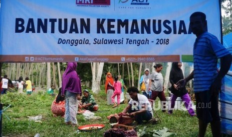 Ibu-ibu dan bapak-bapak pengungsi bergotong royong memotong-motong daging sapi dan memasak di dapur umum Posko Kemanusiaan ACT, di desa Lompio, Kabupaten Sirenja, Donggala Sulawesi Tengah (Ilustrasi)