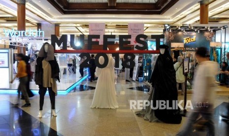 Pengunjung melihat busana yang ditampilkan di sejumlah stan pada acara Muslim Fashion Festival 2018 di Jakarta Convention Center, Jakarta (20/4).