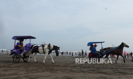 Lebaran di Pantai Parangtritis. Warga memadati kawasan wisata Pantai Parangtritis di Bantul, Yogyakarta, Jumat (7/6/2019).