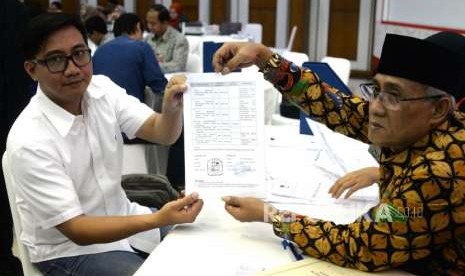 Laporan Awal Dana Kampanye.  Anggota Tim Bendahara TKN 2019 Jokowi - Maruf Amin,  Syafrizal (kiri)  menyerahkan daftar Laporan Awal Dana Kampanye Pemilu 2019 di KPU, Jakarta, Ahad (23/9).