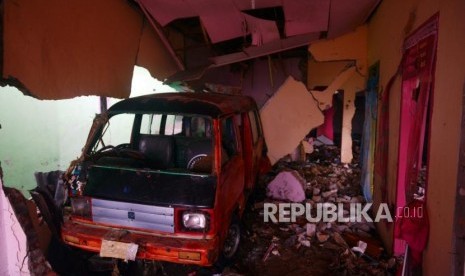 Mobil masuk ke ruangan rumah pasca bencana tsunami di Desa Way Uli, Kalianda, Lampung Selatan, Selasa (25/12).