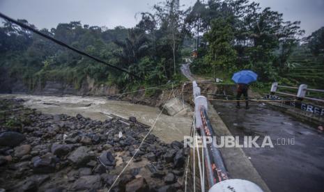 Warga melihat kondisi jembatan perbatasan Kecamatan Sukajaya dan Nanggung yang terputus di Desa Urug, Sukajaya, Kabupaten Bogor, Jawa Barat, Selasa (7/9/2021). 