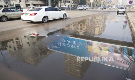 Vehicles pass under a billboard displaying Cristiano Ronaldo wearing a shirt of the Saudi Arabian club Al-Nassr with Arabic reading, 