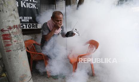  Seorang warga memegang hidung dan radio portabelnya saat dia mencoba menghindari disinfektan yang digunakan. Dalam kondisi normal, membersihkan permukaan dan objek di rumah cukup menggunakan sabun dan deterjen. Gunakan sabun dan deterjen untuk membersihkan area yang sangat sering disentuh secara rutin seperti gagang pintu, meja, pegangan, saklar lampu, dan meja dapur. 