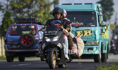 Pemudik bersepeda motor melintas di kawasan Purwakarta, Jawa Barat. Enesis Group bangun 15 Posko mudik Rileks Sehat Adem dan bagikan Healthy Kit