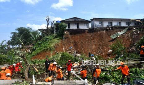 Sejumlah petugas Basarnas dan BPBD Kota Bogor melakukan pencarian korban tanah longsor di Gang Barjo, Kampung Kebon Jahe, Kelurahan Kebon Kelapa, Kota Bogor, Jawa Barat, Kamis (13/10/2022). Pemerintah Kota Bogor mencatat sebanyak delapan warga di kampung tersebut tertimbun tanah longsor saat hujan deras pada Rabu (12/10/2022) sore dengan empat warga selamat dievakuasi, satu warga meninggal dunia dan tiga warga lainnya masih dalam proses pencarian. 