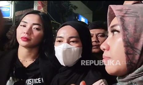 Linda (memakai masker), yang disebut kerasukan arwah Vina, usai menjalani pemeriksaan di Mapolres Cirebon Kota, Senin (27/5/2024) malam.