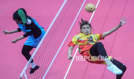 Pesepak takraw putri Sulawesi Tengah Widya Andrini Modjunju (kanan) mencoba melakukan smes ke arah atlet sepak takraw putri Lampung Nining Sapitri (kiri) dalam pertandingan babak penyisihan sepak takraw beregu putri PON Papua di GOR Trikora Universitas Cenderawasih, Jayapura, Papua, Jumat (1/10/2021). Tim sepak takraw beregu putri Sulteng mengalahkan tim sepak takraw beregu putri Lampung dengan skor 2-1 (21-10, 18-21, dan 21-13). 