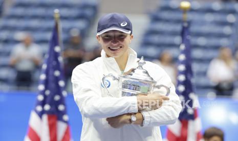 Iga Swiatek dari Polandia merayakan dengan trofi kejuaraan setelah mengalahkan Ons Jabeur dari Tunisia selama pertandingan final putri di Kejuaraan Tenis AS Terbuka di Pusat Tenis Nasional USTA di Flushing Meadows, New York, AS, 10 September 2022. AS Terbuka berlangsung dari 29 Agustus hingga 11 September.