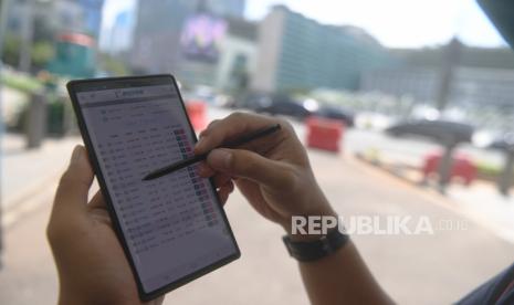 Investor memantau perdagangan saham melalui gawainya di Jakarta, Jumat (13/11/2020). PT Mirae Asset Sekuritas Indonesia optimistis industri reksa dana di pasar modal Indonesia akan tumbuh mencapai Rp 1.000 triliun dalam tiga tahun ke depan atau lebih cepat.