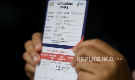 Tenaga kesehatan menunjukkan kartu vaksinasi COVID-19 seusai penyuntikan vaksin CoronaVac,  di Puskesmas Tanah Baru, Depok, Jawa Barat, Jumat (15/1/2021). Sebanyak 1,48 juta tenaga kesehatan sebagai garda terdepan dalam melayani pasien COVID-19 akan divaksin secara bertahap hingga februari 2021. 