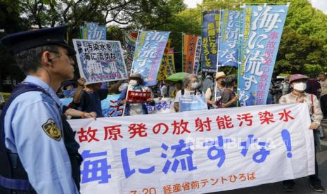 Demonstrators hold placards and banners during a protest against the release of treated wastewater by the Tokyo Electric Power Company (TEPCO) Fukushima Daiichi Nuclear Power Plant into the sea near the TEPCO headquarters in Tokyo, Japan, 20 July 2023. The Japanese government and the International Atomic Energy Agency (IAEA) have approved the release of the treated wastewater into the ocean and said the water will be released this summer. The banner reads Don