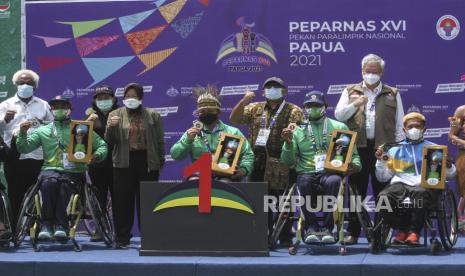 Menteri Sosial Tri Rismaharini (keempat kiri) berfoto dengan peraih medali tenis kursi roda tunggal putra Peparnas XVI di Sian Soor, Jayapura, Papua, Sabtu (13/11/2021). Kehadiran Mensos guna mendukung prestasi para atlet penyandang disabilitas sekaligus meninjau pertandingan tenis kursi roda Peparnas XVI Papua. 