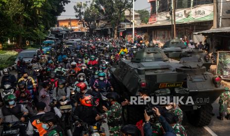 Petugas gabungan mengimbau pengendara untuk memutar balik saat melewati posko penyekatan pada jam berangkat kerja di Jalan Lenteng Agung, Jakarta Selatan, Senin (5/7). Penyekatan pada hari ketiga Pemberlakuan Pembatasan Kegiatan Masyarakat (PPKM) Darurat tersebut menyebabkan kemacetan sepanjang 2 kilometer. Republika/Thoudy Badai