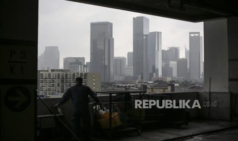 Petugas kebersihan bekerja dengan latar belakang deretan gedung bertingkat di kawasan Jakarta Selatan, Kamis (18/2/2021). Gubernur DKI Jakarta menetapkan Peraturan Gubernur Nomor 118 Tahun 2020 tentang Izin Pemanfaatan Ruang untuk mempercepat perizinan pembangunan gedung dan mendorong geliat sektor properti, sebagai salah satu sektor yang memiliki multiplier effects terhadap pemulihan perekonomian akibat pandemi COVID-19. 