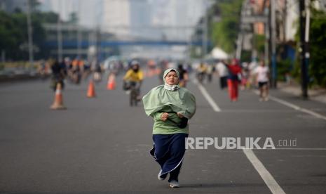 Warga berolahraga saat Hari Bebas Kedaraan Bermotor (HBKB) atau Car Free Day (CFD) di Jalan Gajah Mada, Jakarta, Ahad (28/6). Pemprov DKI Jakarta menggelar HBKB di 32 lokasi baru untuk menggantikan HBKB yang ditiadakan di jalan Sudirman-Thamrin dengan alasan menghindari terjadinya krumunan warga untuk mencegah penyebaran Covid-19.Prayogi/Republika