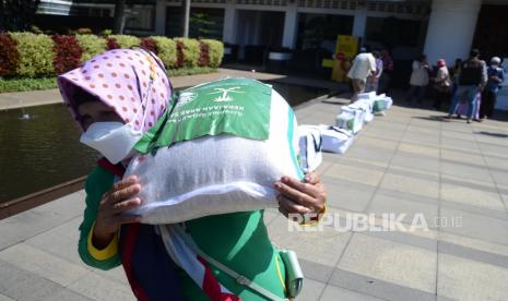  688 Ribu Orang Mendapat Manfaat dari Program Buka Puasa Raja Salman. Foto:  Penerima bantuan membawa paket pangan usai serah terima Bantuan 100 Paket Pangan dari Raja Salman untuk warga Kota Bandung, melalui Baznas (Badan Amil Zakat Nasional) kepada Pemkot Bandung, di Balai Kota Bandung, Rabu (13/4). Bantuan kemanusiaan dari Kerajaan Arab Saudi tersebut sebagai bentuk kepedulian sosial kepada kaum Muslimin Indonesia saat Ramadhan khususnya yang terkena dampak pendemi.