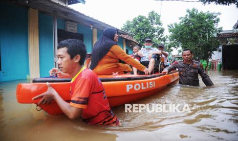 Petugas mengevakuasi warga saat banjir merendam kawasan Perumahan Sawangan Asri, Depok, Jawa Barat, Selasa (4/3/2025). Banjir dengan tinggi air mencapai 1,5 meter tersebut disebabkan luapan Kali Pesanggrahan yang melintas di belakang perumahan.  Menurut warga air mulai menggenangi sejak Senin pukul 22.00 WIB. Banjir di perumahan tersebut merendam sekitar 40 rumah warga.